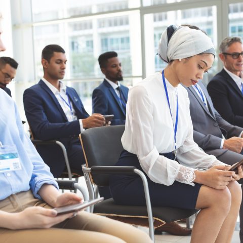 Side view of mixed race businesswoman using digital tablet in a business seminar in conference room